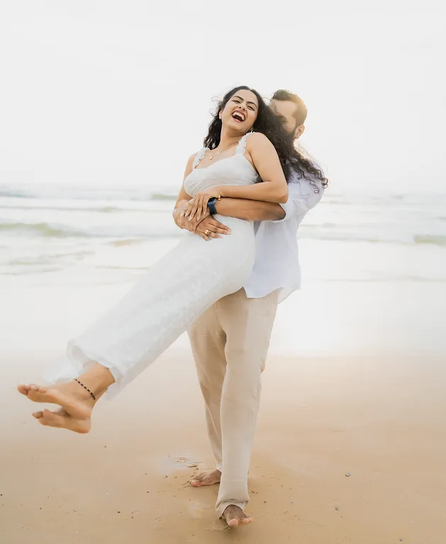 Outdoor pre wedding photoshoot of couple sitting together by the lake