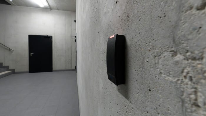 Electronic access-card reader mounted beside a secured office door