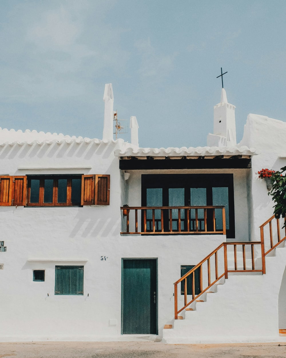 Houses above the limestone cliffs on the coast of Menorca