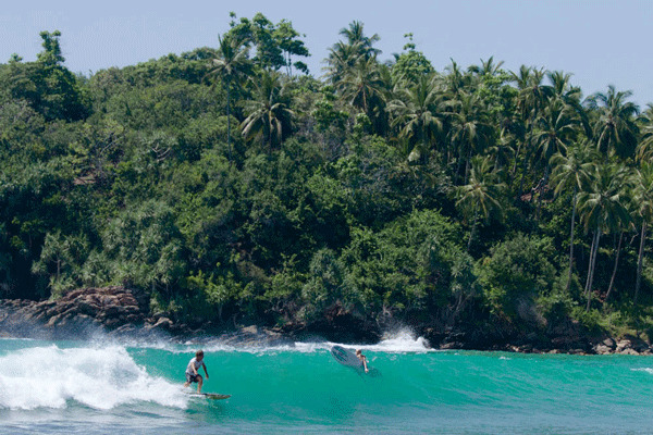 Surfing at Hiriketiya horseshoe bay Sri Lanka