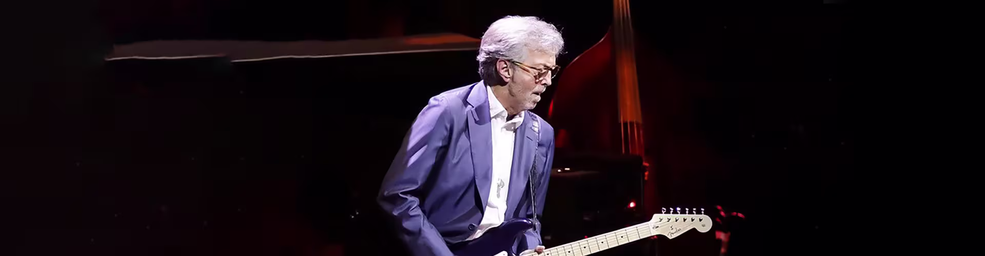 Eric Clapton playing guitar on stage