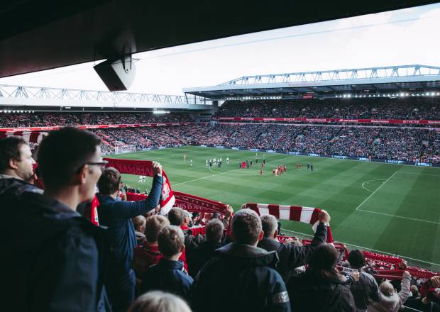 Liverpool fans watching a game at Anfield Stadium