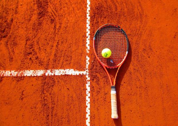 Tennis racket on a clay court  