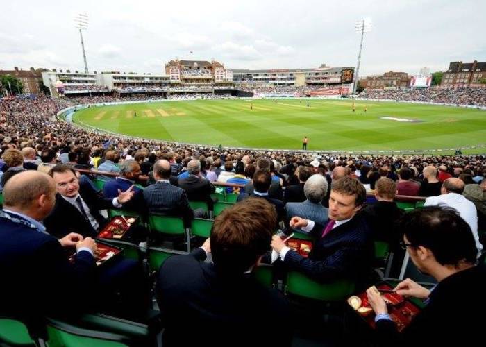 Business Men watching Cricket