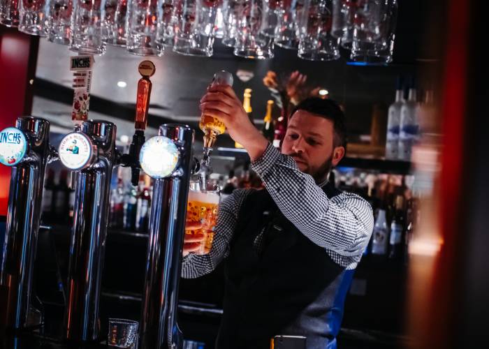 Bar staff pulling pint