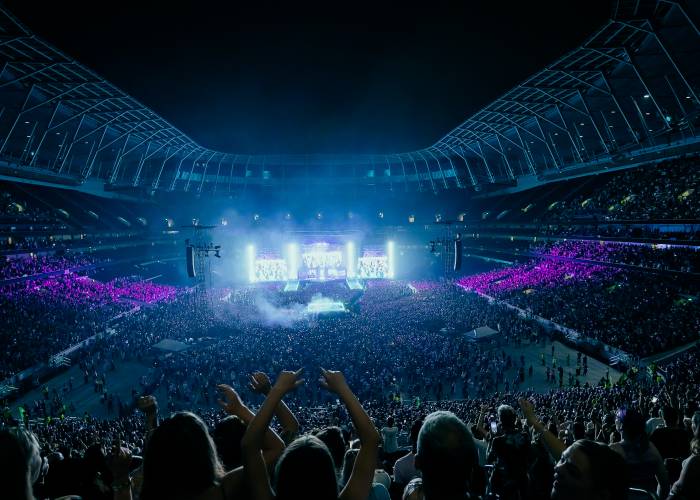 Concert goers watching live performance at Tottenham Hotspur Stadium