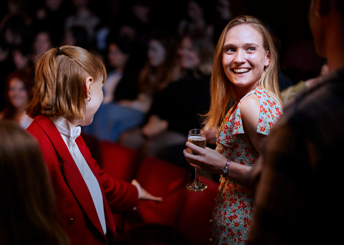 Red Coat Butler showing guest to her seat