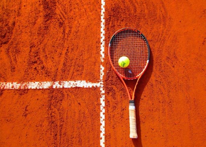 Tennis racket on a clay court