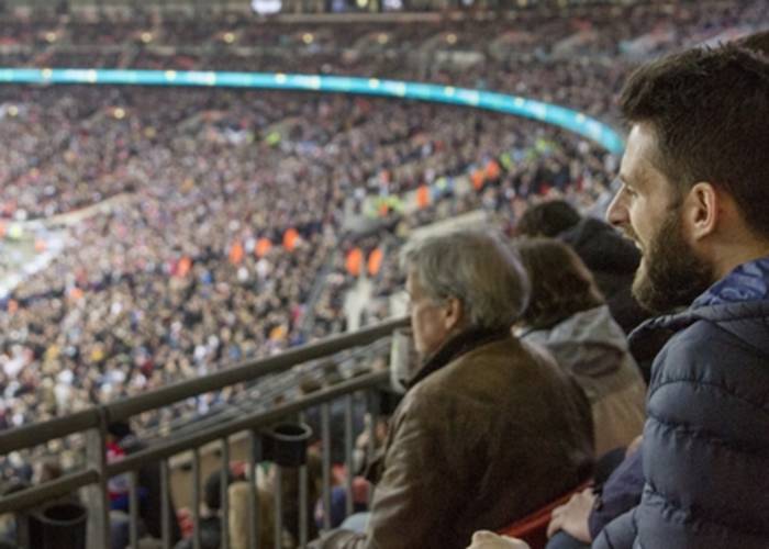 Fans watching at Wembley Stadium