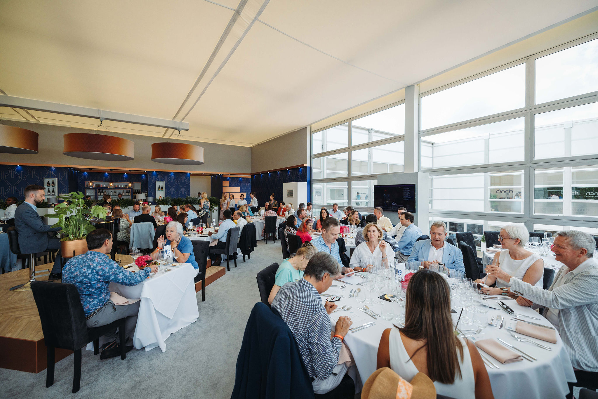 Guests enjoying hospitality in the Club Lounge at Queens Club