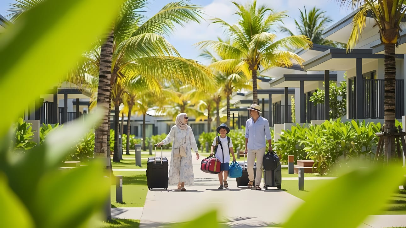 A happy Muslim family with a child walks with luggage on a sunny day at a luxurious tropical resort.