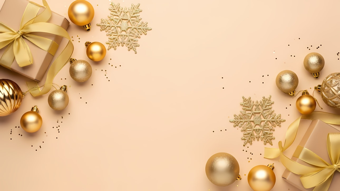 Festive gold Christmas decorations, gift boxes, and snowflakes on a light background with copy space.