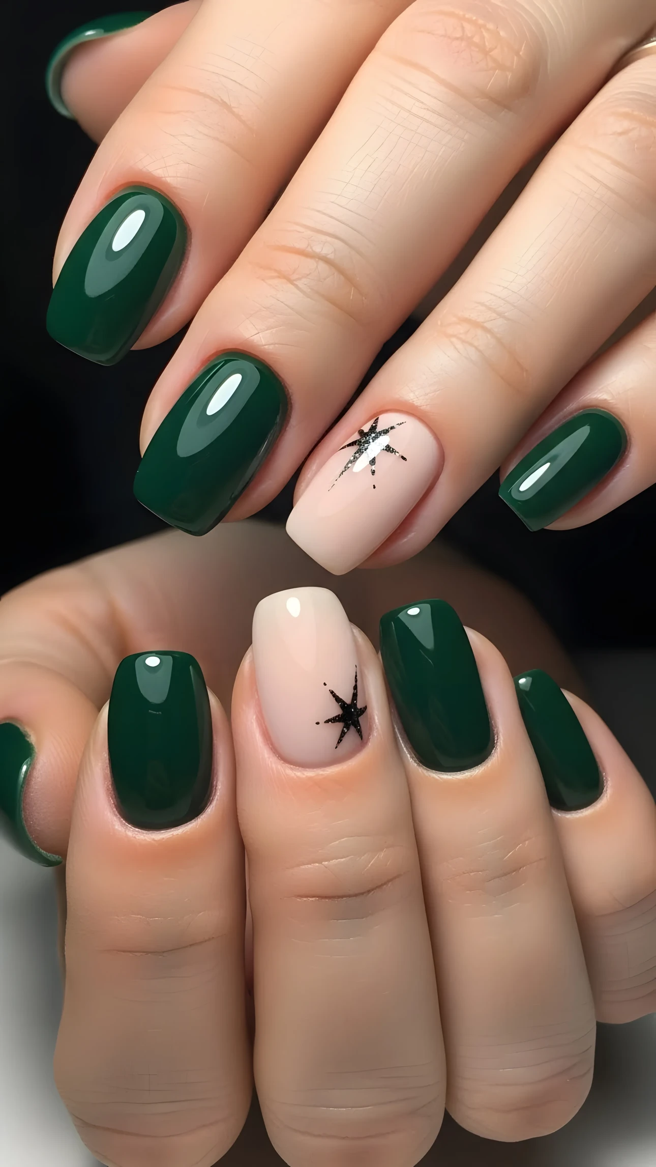 Close-up of manicured hands with emerald green nails and star art on nude nails, showcasing elegant beauty and style.