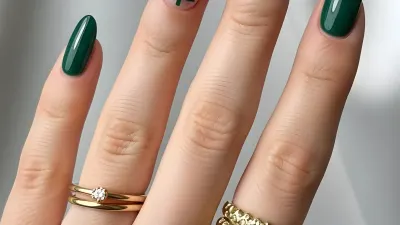 Hand with Emerald Green Nails and Christmas Tree Nail Art