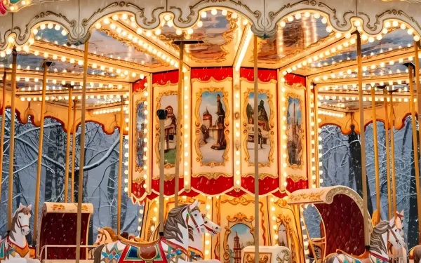 Evoke nostalgia with this vintage carousel image, featuring ornate details and a wintery backdrop. Ideal for seasonal campaigns and whimsical designs.