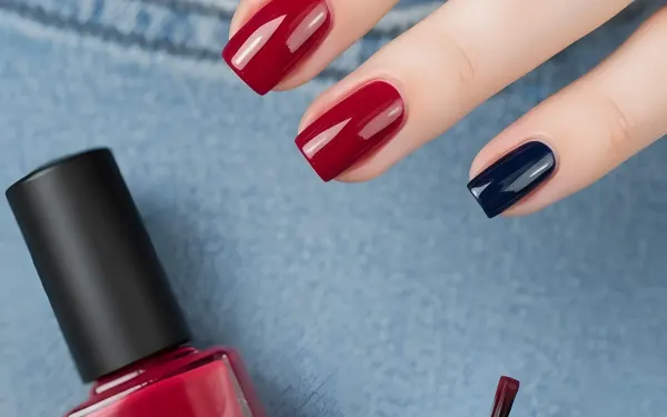 Elevate your designs with this striking nail art image, showcasing a bold red and navy manicure. Perfect for beauty blogs and cosmetic ads.