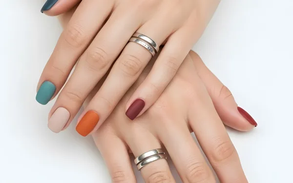 Elevate your designs with this image of hands featuring stylish matte nail polish and silver rings. Perfect for beauty and fashion branding projects.