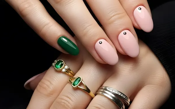 Elevate your designs with this image of manicured hands featuring emerald jewelry and trendy nail art. Perfect for luxury beauty and lifestyle projects.