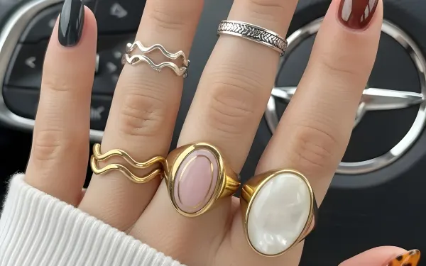 Elevate your designs with this image of a woman's hand featuring a stylish manicure and rings. Ideal for beauty blogs and jewelry ads. Ready for commercial projects.