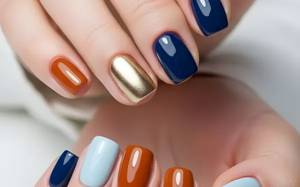 Elevate your designs with this manicure image featuring navy, gold, and caramel nail polish. Perfect for beauty blogs or salon marketing materials.