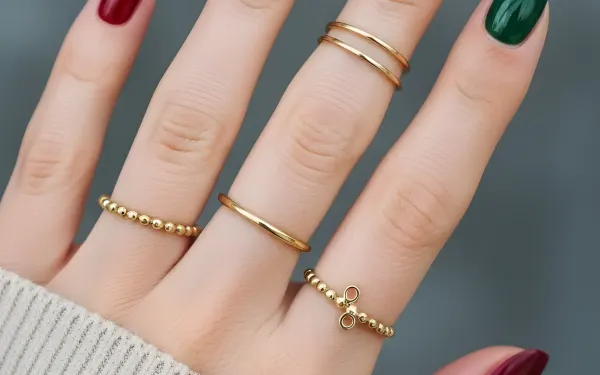 Elevate your designs with this close-up of a manicured hand featuring vibrant nail polish and delicate gold rings. Perfect for beauty and fashion projects.