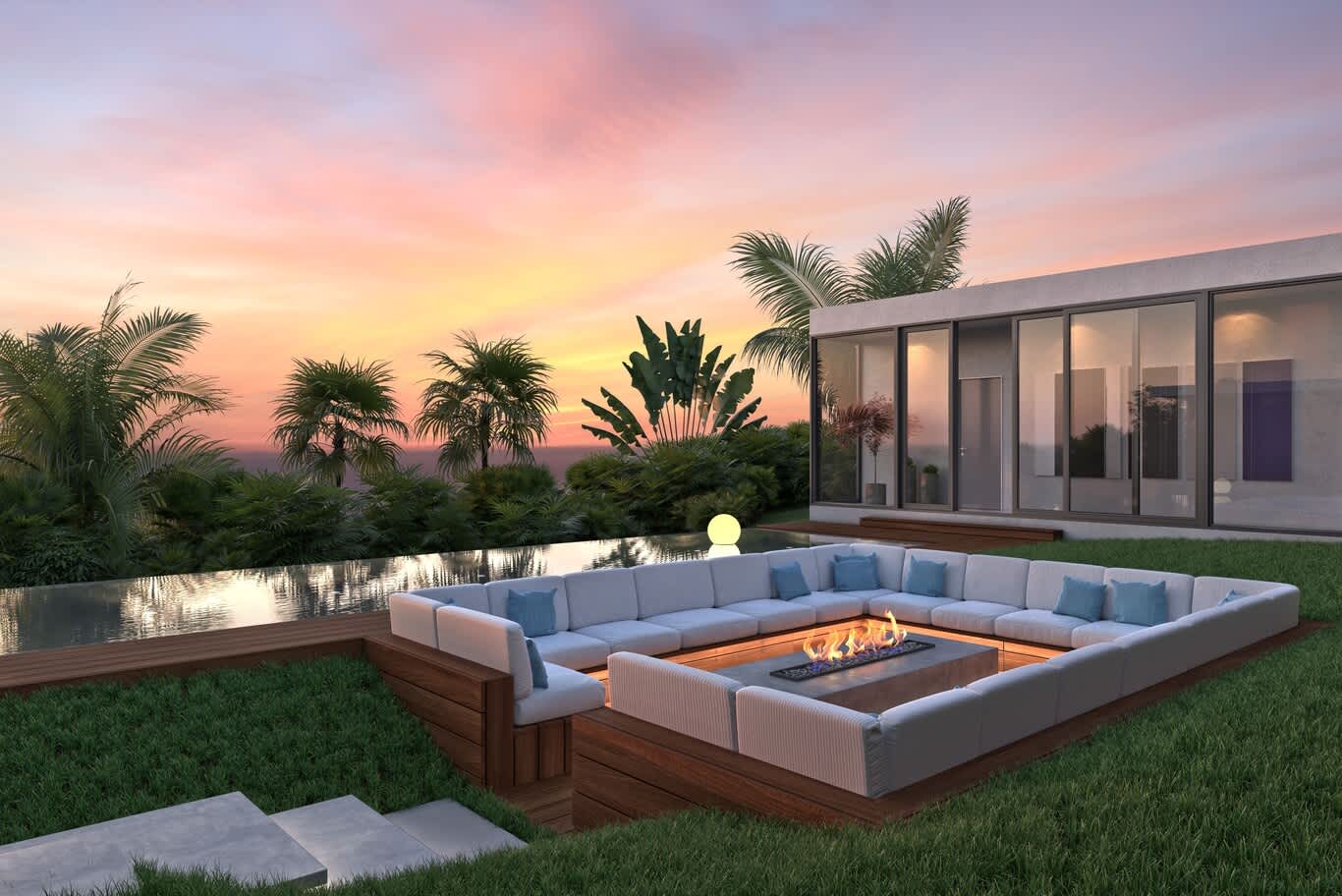 Sunken fire pit lounge beside an infinity pool in a landscaped garden at sunset
