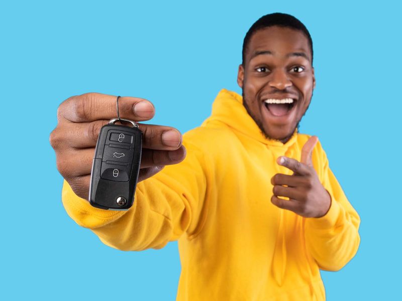 Man with newly purchased car after recieving an interest-free loan