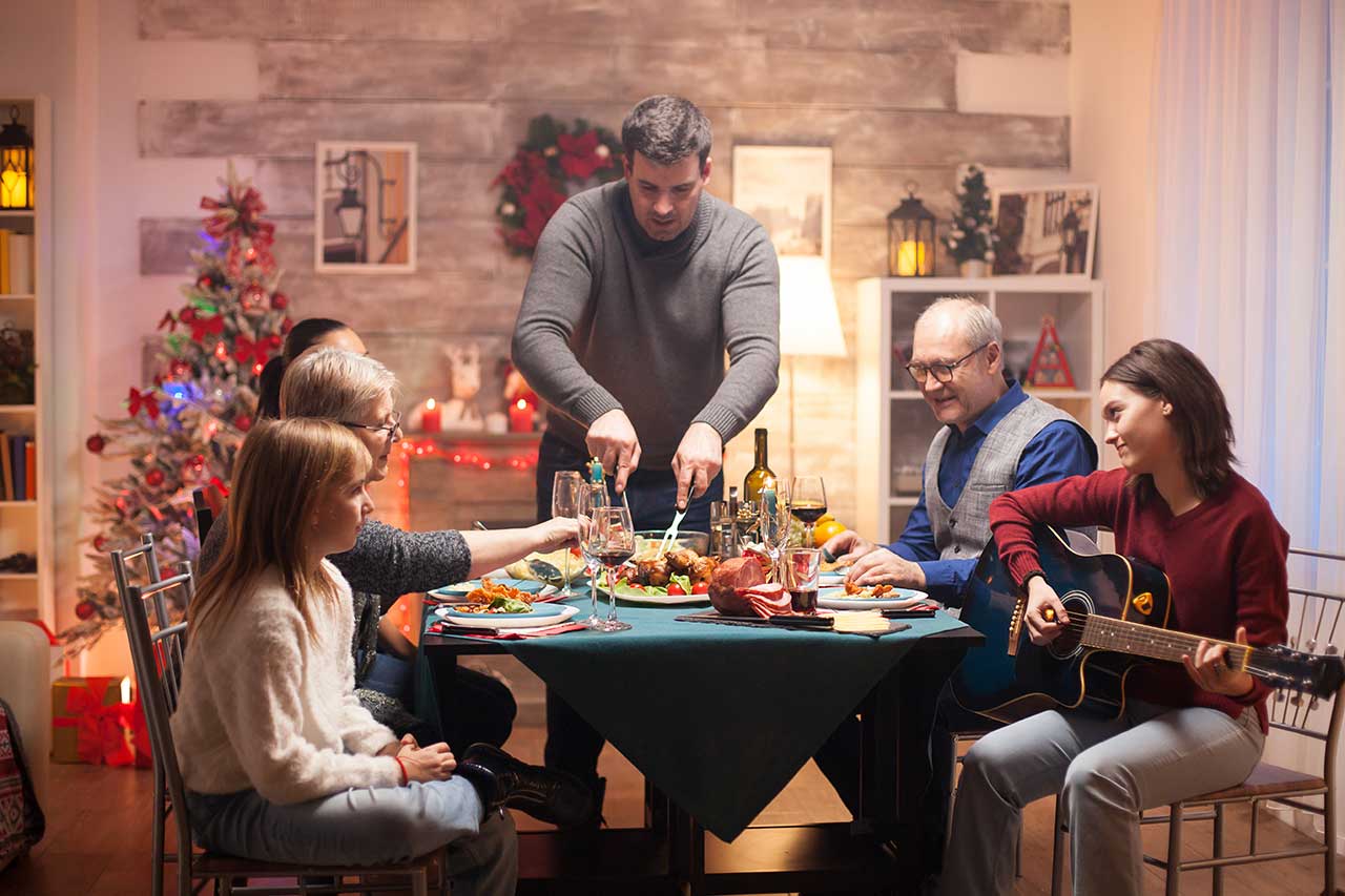 Thanksgiving dinner with family and girl playing guitar
