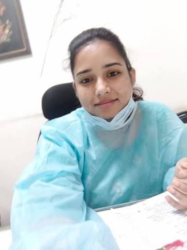 Dr. Neha Saxena holding Pure Ayur Herbs formulation