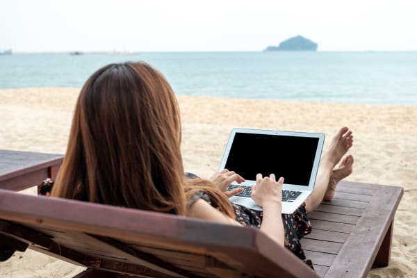 Woman struggling to switch off from work on holiday