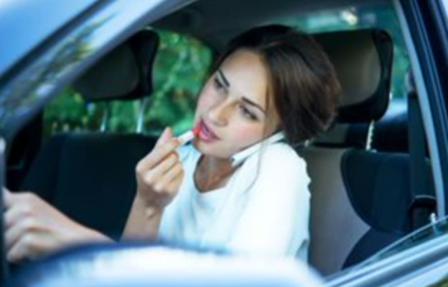 Woman applying makeup while driving