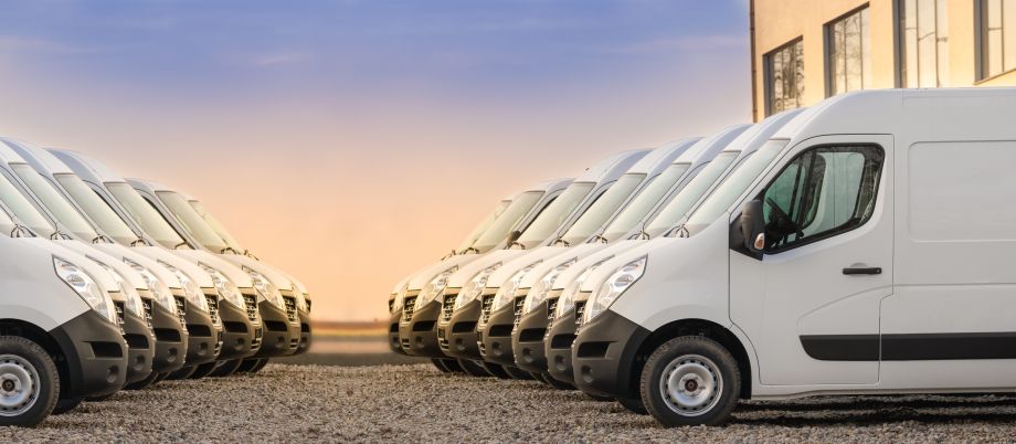 A fleet of vans parked and waiting for business fleet solutions