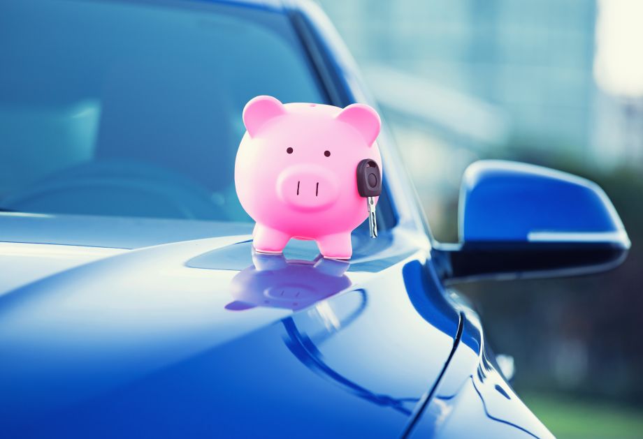 A piggy bank on a car, indicating driving techniques can save businesses fuel