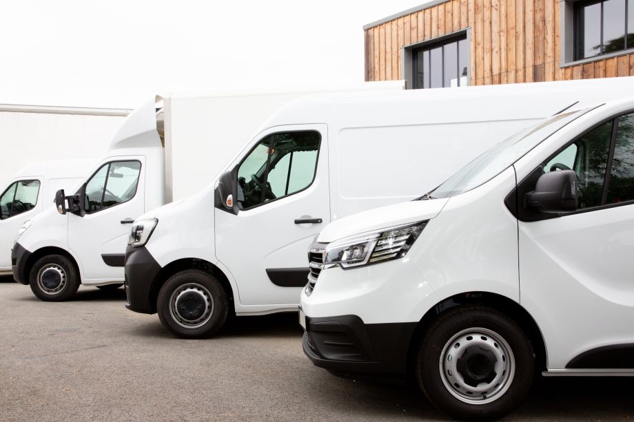 White fleet vehicles parked outside a business