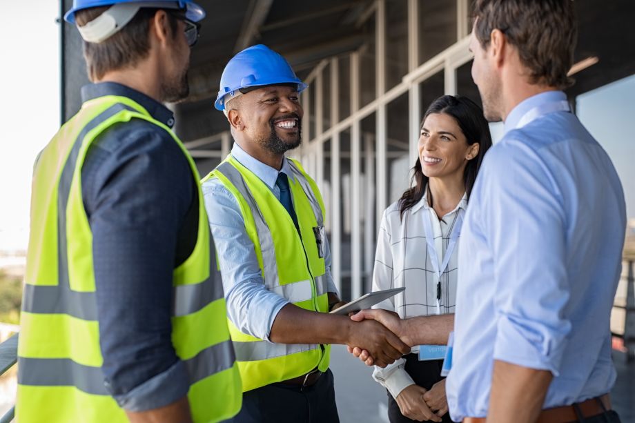 Contractors shaking hands on a building site