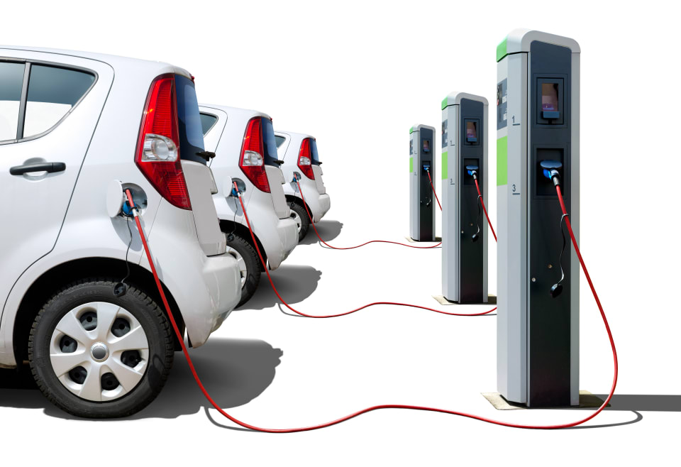 A line of EV cars charging at charge points