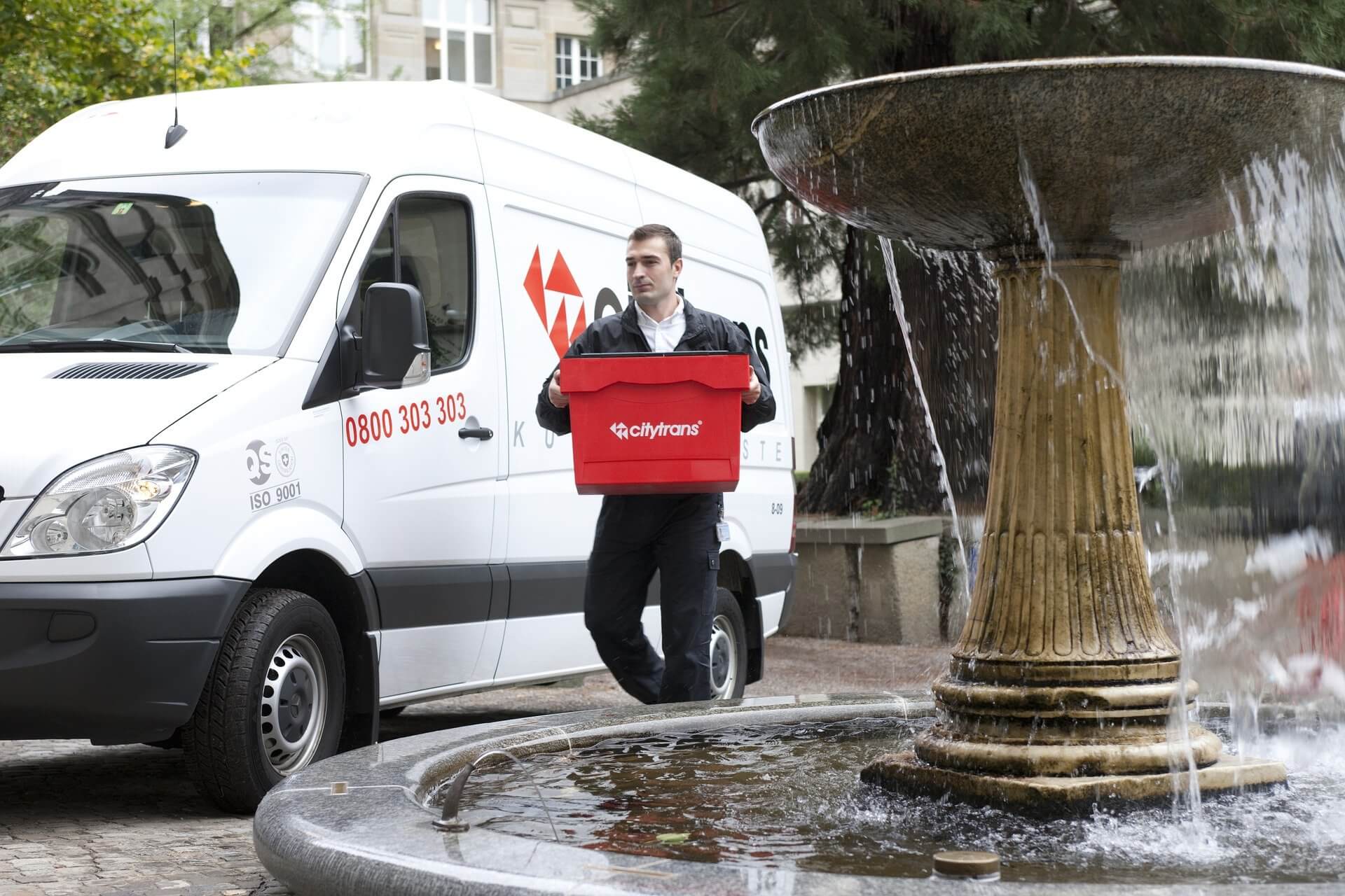 A delivery driver takes a package to a customer