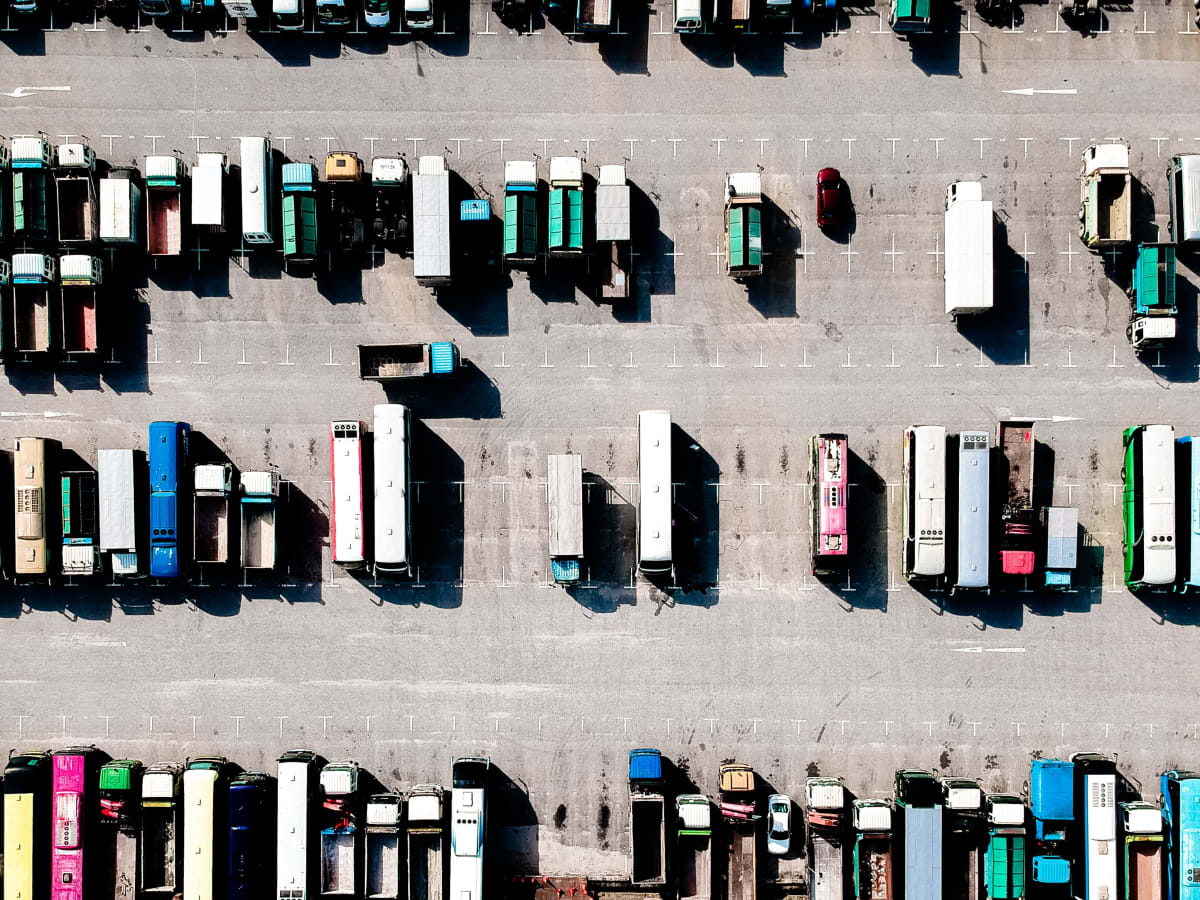 Fleet maintenance vehicles and trucks parked in a large car park