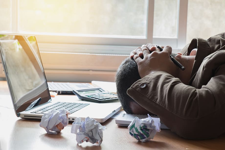 Man stressing on laptop