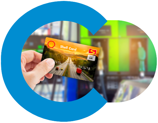 shell fuel card being held up infront of a fuel station