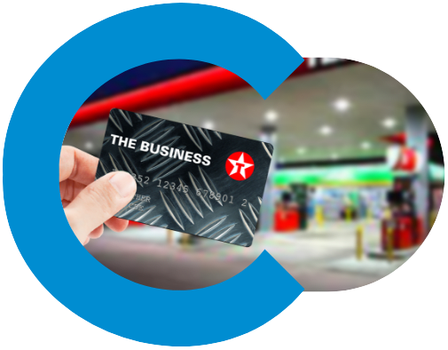 Texaco fuel card being held up infront of a fuel station