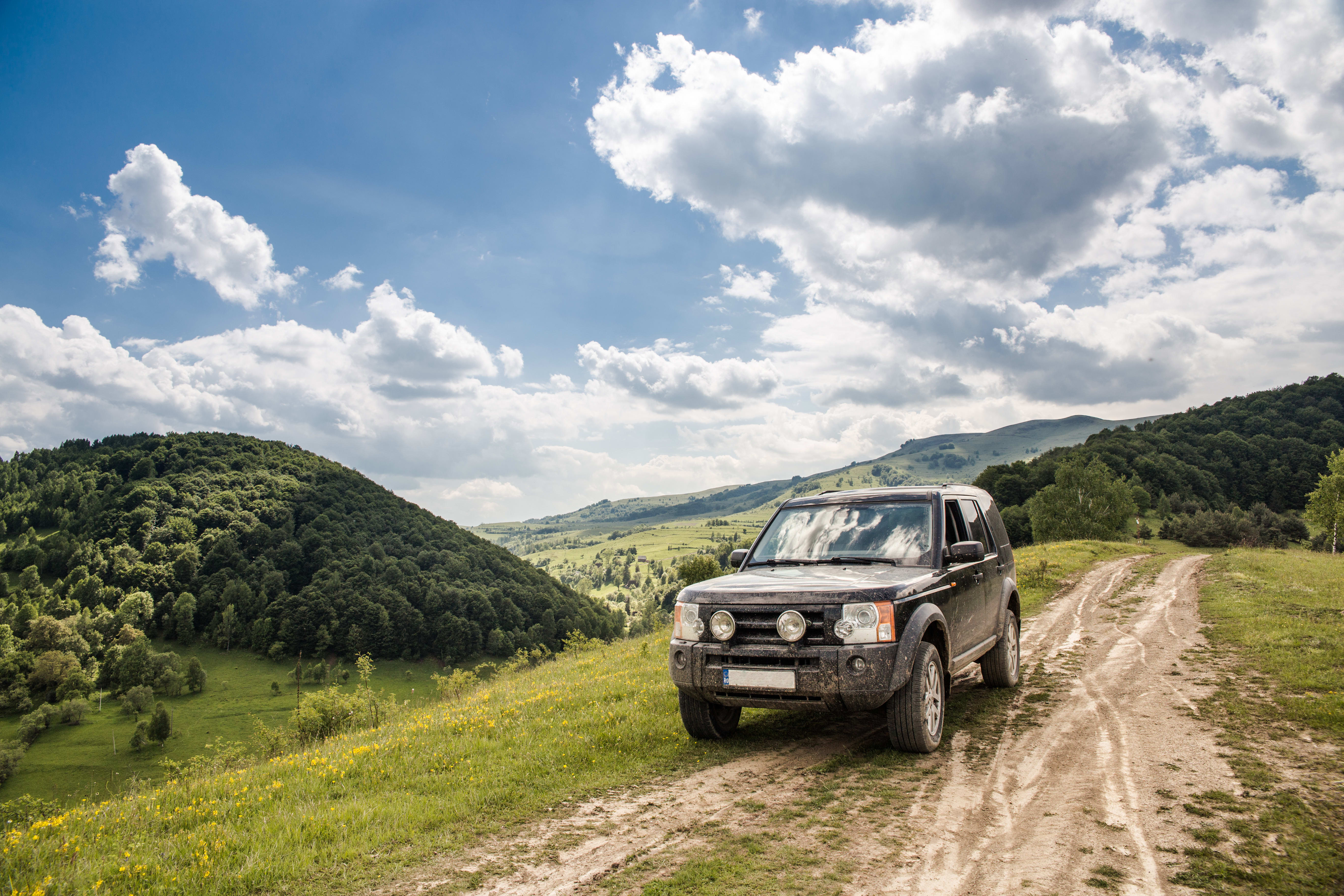 Land rover tracker for vehicle asset on countryside road 