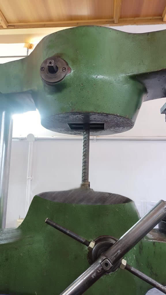 Close-up of tensile test machine gripping rebar