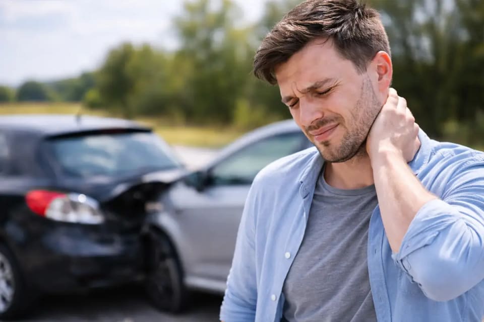 Injured person holding neck pain after an Idaho car accident