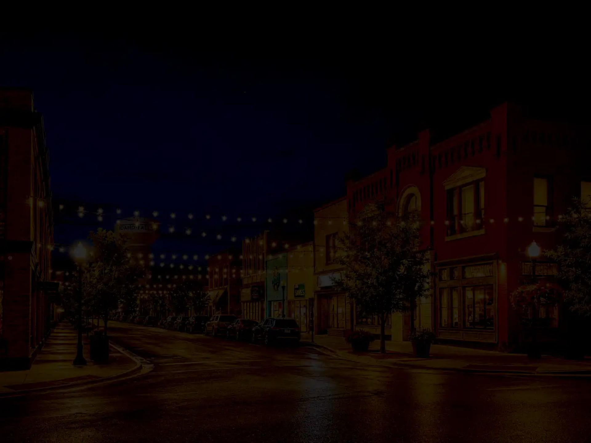 Downtown Idaho Falls skyline at dusk behind the hero section