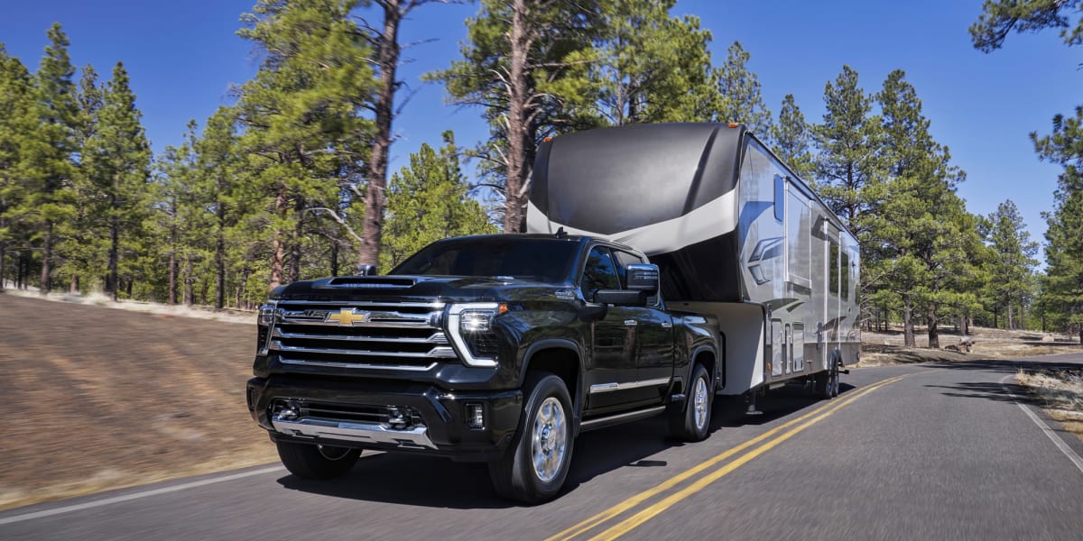 2026 Chevrolet Silverado 2500 HD towing a large fifth-wheel trailer