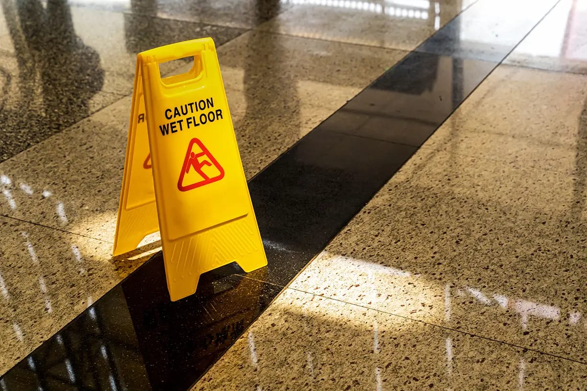 Caution wet floor sign on a marble floor