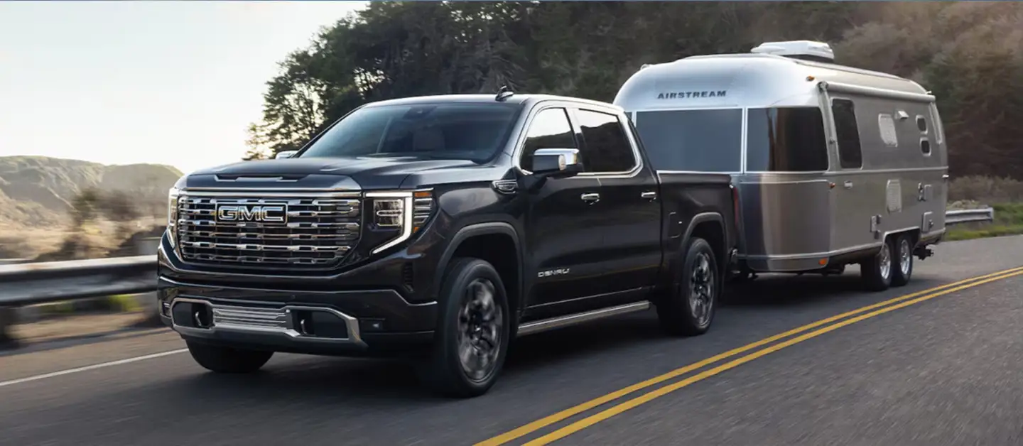 GMC Sierra towing a silver camper