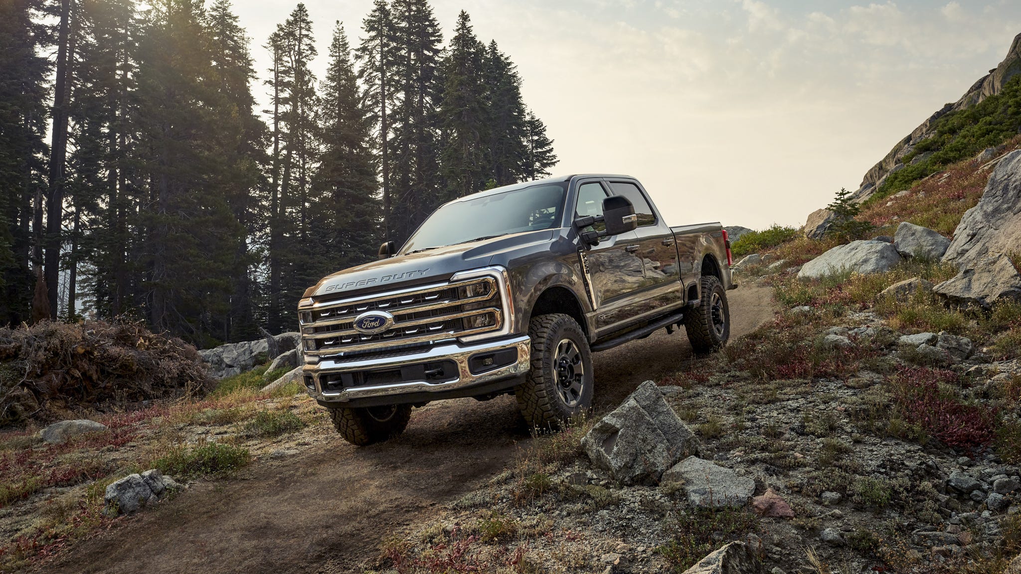 Ford Super Duty truck driving on a gravel road