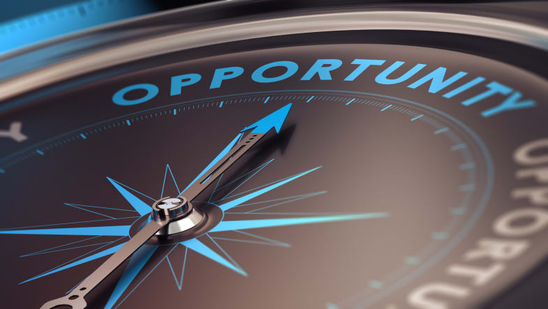 Compass with needle pointing to the word opportunity
